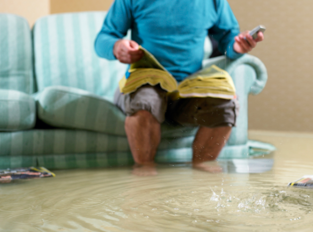 Man Calling Water Damage Repair In Flooded Room